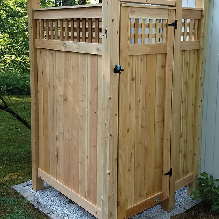 Outdoor House Mount Shower Kit shown with Lattice on pebbles under floor