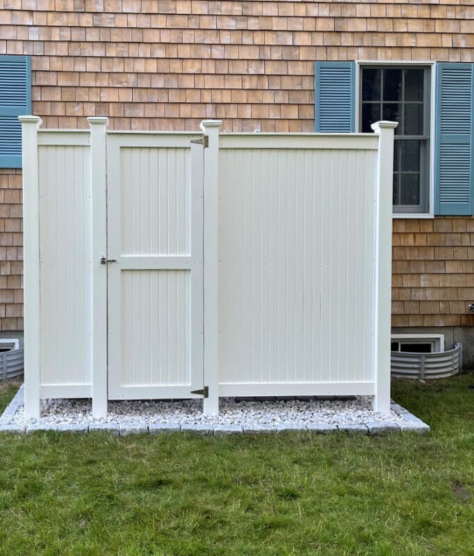 diy shower outdoor changing room against shingled home