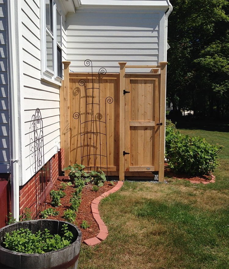 wood house mount outdoor shower in backyard