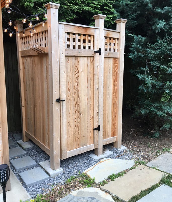 wood outside shower stall in backyard