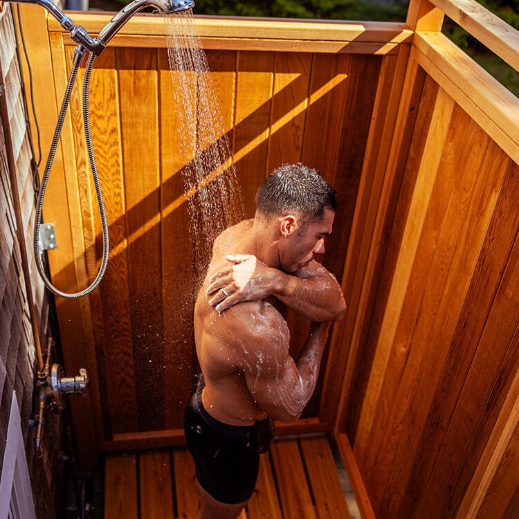 man inside outdoor shower cedar